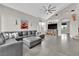 Spacious living room with vaulted ceilings, tile floors, a large sectional sofa, and an entertainment center at 9705 Cameo Rose Ln, Las Vegas, NV 89134