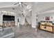 Expansive living room featuring tile floors, high ceilings, stylish decor, and a seamless transition to the staircase at 9705 Cameo Rose Ln, Las Vegas, NV 89134