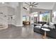 Open-concept living area with soaring ceilings, neutral paint, a large leather sofa, and tile flooring throughout at 9705 Cameo Rose Ln, Las Vegas, NV 89134