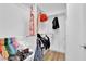 Bright walk-in closet with a rack of colorful clothes and hardwood floors at 9705 Cameo Rose Ln, Las Vegas, NV 89134