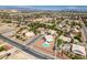 An expansive aerial view showcases the neighborhood layout, nearby streets and surrounding desert landscape at 10290 Marion Morrison Ct, Las Vegas, NV 89183