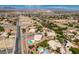 An expansive aerial view showcases the neighborhood layout, nearby streets and surrounding desert landscape at 10290 Marion Morrison Ct, Las Vegas, NV 89183