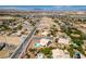An expansive aerial view showcases the neighborhood layout, nearby streets and surrounding desert landscape at 10290 Marion Morrison Ct, Las Vegas, NV 89183