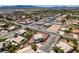Aerial view of a neighborhood with single Gathering homes, desert landscaping and city views at 10290 Marion Morrison Ct, Las Vegas, NV 89183