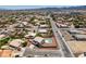 Wide aerial shot of a neighborhood featuring many homes with pools, fenced yards, and desert landscaping at 10290 Marion Morrison Ct, Las Vegas, NV 89183