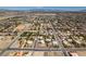 Wide aerial shot of a city neighborhood featuring many homes and desert landscaping at 10290 Marion Morrison Ct, Las Vegas, NV 89183