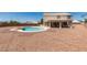 Expansive backyard featuring a pool, desert landscaping, and covered patio, ideal for entertaining at 10290 Marion Morrison Ct, Las Vegas, NV 89183
