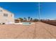 Desert landscaped backyard featuring a pool, covered patio, and plenty of space for outdoor activities at 10290 Marion Morrison Ct, Las Vegas, NV 89183