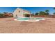 A backyard pool with a fountain surrounded by desert landscaping. The back of the home is visible in the background at 10290 Marion Morrison Ct, Las Vegas, NV 89183