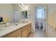 Well-lit bathroom featuring a long vanity with cabinets and open doorway to the toilet area at 10290 Marion Morrison Ct, Las Vegas, NV 89183