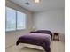 Bedroom featuring a cozy bed, window, and neutral decor at 10290 Marion Morrison Ct, Las Vegas, NV 89183