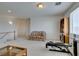 A bonus room is furnished with a love seat and exercise equipment at 10290 Marion Morrison Ct, Las Vegas, NV 89183