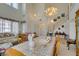 Open-concept dining room with lots of natural light, featuring an adjoining staircase, floral decor, and traditional accents at 10290 Marion Morrison Ct, Las Vegas, NV 89183