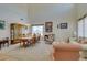 Open-concept living and dining areas feature high ceilings, large windows, and seamless transitions to the living room at 10290 Marion Morrison Ct, Las Vegas, NV 89183
