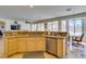 Kitchen showcasing granite countertops, a stainless steel dishwasher, and open access to the patio via a large window at 10290 Marion Morrison Ct, Las Vegas, NV 89183