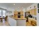 Open kitchen featuring granite countertops, stainless steel appliances, and a breakfast bar connecting to an informal dining area at 10290 Marion Morrison Ct, Las Vegas, NV 89183