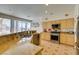 Bright kitchen with stainless steel appliances, a peninsula, and abundant natural light from the adjacent breakfast nook window at 10290 Marion Morrison Ct, Las Vegas, NV 89183