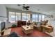 Bright living room with brick fireplace, tan sofa, and backyard pool access at 10290 Marion Morrison Ct, Las Vegas, NV 89183