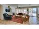 Comfortable living room showcasing fireplace, TV, and backyard access at 10290 Marion Morrison Ct, Las Vegas, NV 89183