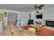Inviting living room with a fireplace, ceiling fan, and plush seating at 10290 Marion Morrison Ct, Las Vegas, NV 89183