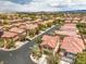 An elevated view of a residential area boasting neatly arranged homes, mature trees, and orderly street layout at 10294 Running Falls St, Las Vegas, NV 89178