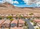 Wide aerial perspective showing a peaceful neighborhood nestled in a scenic desert setting with distant mountain views at 10294 Running Falls St, Las Vegas, NV 89178