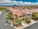 Aerial view of a suburban home showcasing its lush landscaping, driveway, and surrounding neighborhood at 10294 Running Falls St, Las Vegas, NV 89178