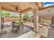 Inviting covered patio overlooks a landscaped backyard with decorative pavers and an outdoor dining area at 10294 Running Falls St, Las Vegas, NV 89178
