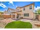 Stunning backyard with covered patio, manicured synthetic grass, and desert landscaping for a serene outdoor space at 10294 Running Falls St, Las Vegas, NV 89178