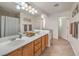 Bright bathroom featuring double sinks, a large mirror, and a separate shower and bathtub at 10294 Running Falls St, Las Vegas, NV 89178