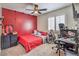 Cozy bedroom with red accent wall, ceiling fan, plantation shutters and modern decor at 10294 Running Falls St, Las Vegas, NV 89178