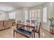 Bright dining room with a table, bench, and shutters for natural light control at 10294 Running Falls St, Las Vegas, NV 89178
