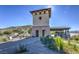 A stone and stucco entrance with a tower leads into the Mountain's Edge community at 10294 Running Falls St, Las Vegas, NV 89178