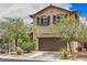 Two-story home featuring a well-maintained lawn, landscaping, and a two car garage at 10294 Running Falls St, Las Vegas, NV 89178