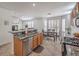 Open kitchen with granite countertops, stainless steel appliances, an island, and dining table at 10294 Running Falls St, Las Vegas, NV 89178