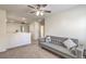Cozy living room featuring a comfortable sofa, neutral carpet, and ample natural light at 10294 Running Falls St, Las Vegas, NV 89178