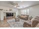 Comfortable living room with a ceiling fan, media center, couches, and window shutters at 10294 Running Falls St, Las Vegas, NV 89178