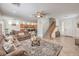 Open concept living room connects to kitchen and entryway with ceiling fan and sofas at 10294 Running Falls St, Las Vegas, NV 89178