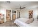 Main bedroom features plush carpeting, a ceiling fan, walk-in closet, and ensuite bath access at 10294 Running Falls St, Las Vegas, NV 89178