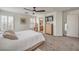 Main bedroom features plush carpeting, a ceiling fan, and ensuite bath access at 10294 Running Falls St, Las Vegas, NV 89178