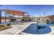 Fun playground with sun shades featuring a vibrant play area with crosswalks, cityscapes, and mountain views at 10294 Running Falls St, Las Vegas, NV 89178