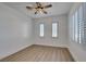 Bright, empty bedroom with modern flooring, crisp white walls, and windows with white shutters at 10389 Felice Ave, Las Vegas, NV 89135