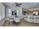 Bright dining area with views to the modern kitchen with bar seating and stylish furnishings throughout the open plan at 10389 Felice Ave, Las Vegas, NV 89135