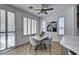 Inviting dining area with a modern marble table and chairs, large windows, and elegant shutters for privacy at 10389 Felice Ave, Las Vegas, NV 89135