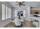 Well-lit dining area featuring a modern table set with stylish chairs, complemented by the kitchen in the background at 10389 Felice Ave, Las Vegas, NV 89135