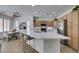 Modern kitchen features a large island with a white countertop, stainless steel appliances, and stylish cabinets at 10389 Felice Ave, Las Vegas, NV 89135