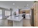 Bright kitchen features a large island with white countertop, stainless appliances, and natural wood cabinets at 10389 Felice Ave, Las Vegas, NV 89135