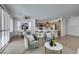 Bright open-concept living space with wood floors, modern kitchen, and comfortable seating area with natural light at 10389 Felice Ave, Las Vegas, NV 89135