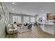Bright living room area featuring hardwood floors, three large windows, and modern decor at 10389 Felice Ave, Las Vegas, NV 89135
