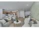 Open concept living area with hardwood floors and updated kitchen in the background at 10389 Felice Ave, Las Vegas, NV 89135